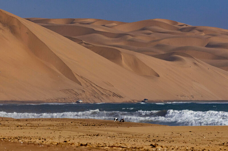 Atlantic surf meeting orange dunes