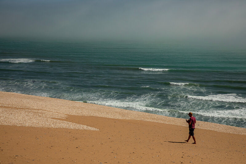 Solo figure on a misty beach, Skeleton Coast
