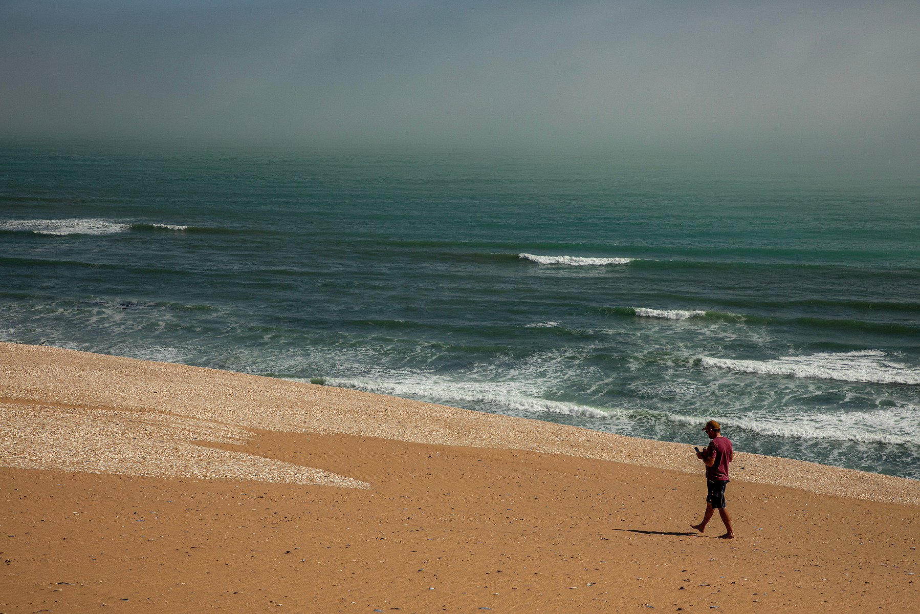 Solo figure on misty beach, Skeleton Coast