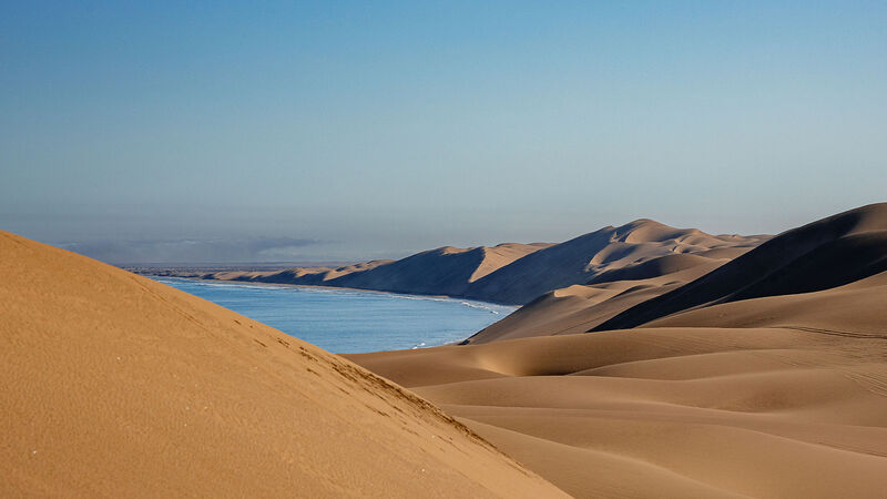 Red dune meeting the Atlantic at Sandwich Harbour, Namib