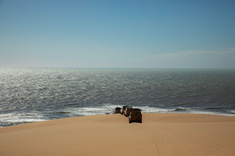4×4 convoy descending to Atlantic surf — fine-art print